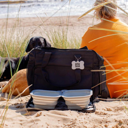 Discover, Mobile Dog Gear Week Away Bag, in Black. The Perfect Away Bag for any Pet Parent, Featuring dividers to stack food and built in waste bag dispenser. Also Included feeding set, collapsible silicone bowls and placemat! The Perfect Gift For travel, meets airline requirements. Available Now at Lords & Labradors