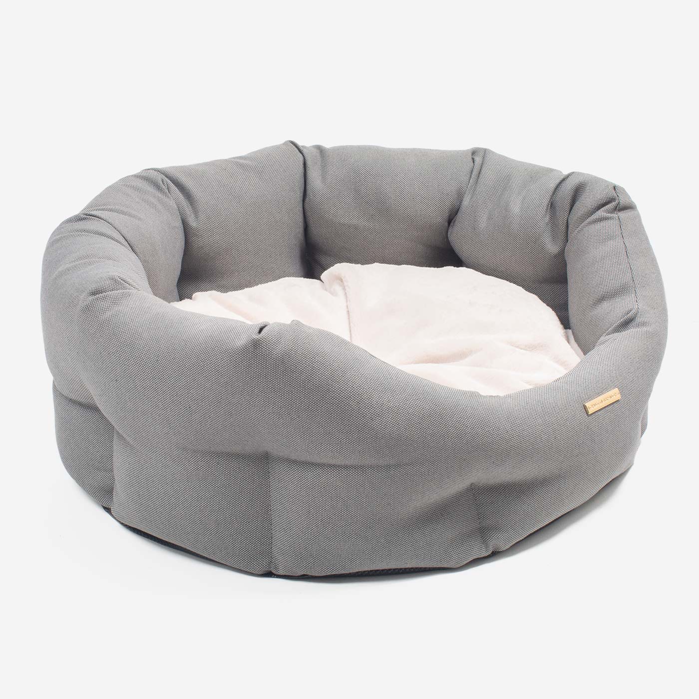 Discover our luxury twill oval dog bed in beautiful sandstone, the ideal choice for dogs to enjoy blissful nap-time, featuring reversible inner cushion with raised sides for dogs who love to rest their head for the ultimate cosiness! Handcrafted in Italy for pure pet luxury! Available now at Lords & Labradors    