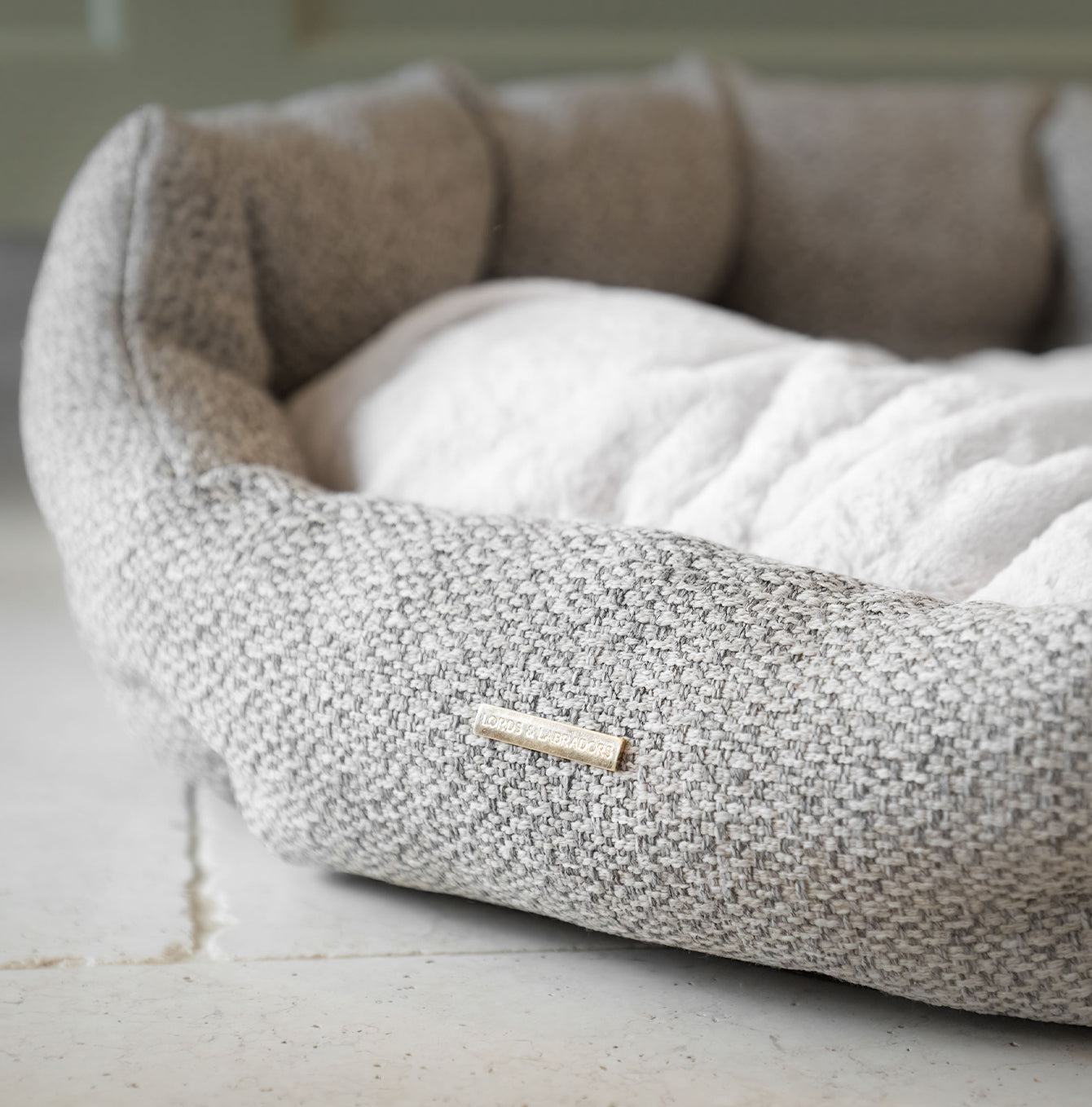 Discover our luxury Herdwick oval dog bed in beautiful pebble, the ideal choice for dogs to enjoy blissful nap-time, featuring reversible inner cushion with raised sides for dogs who love to rest their head for the ultimate cosiness! Handcrafted in Italy for pure pet luxury! Available now at Lords & Labradors 