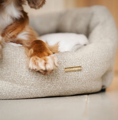 Discover our luxury Herdwick oval dog bed in beautiful sandstone, the ideal choice for dogs to enjoy blissful nap-time, featuring reversible inner cushion with raised sides for dogs who love to rest their head for the ultimate cosiness! Handcrafted in Italy for pure pet luxury! Available now at Lords & Labradors    