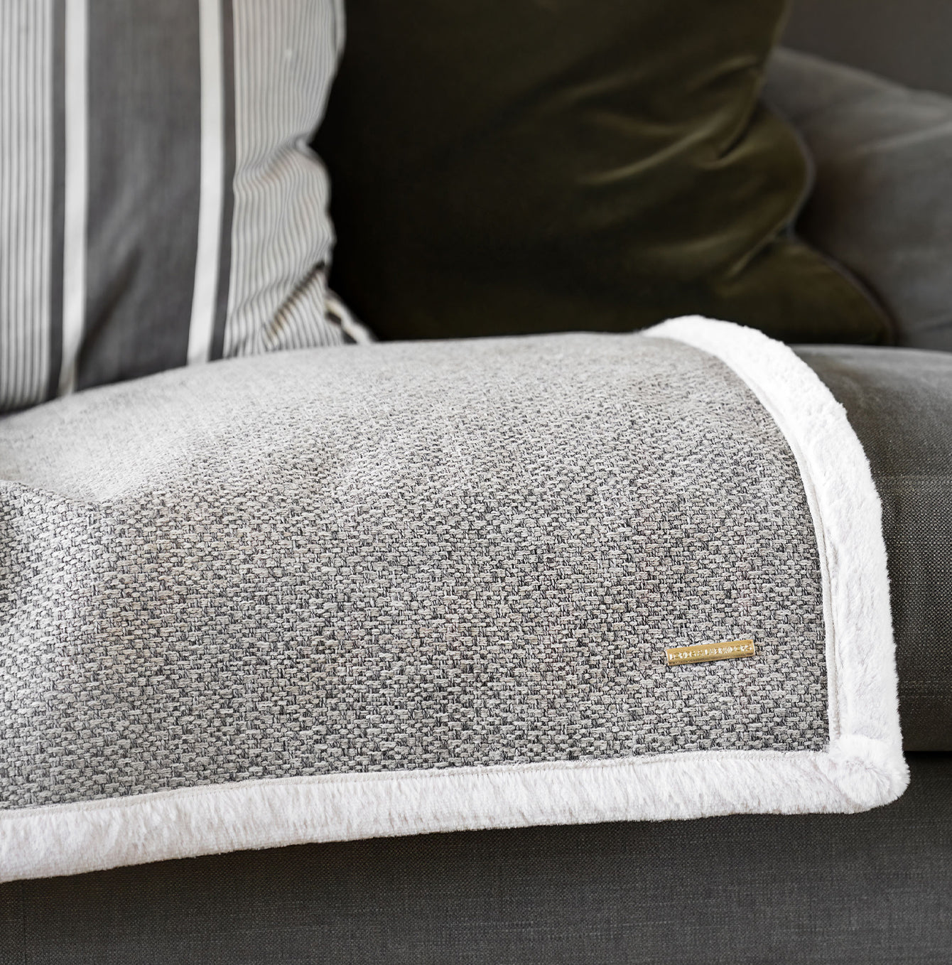 Present your furry friend with our luxuriously thick, plush blanket for your pet. Featuring a reverse side with hardwearing woven fabric handmade in Italy for the perfect high-quality pet blanket! Essentials Herdwick Blanket In Pebble, Available now at Lords & Labradors    