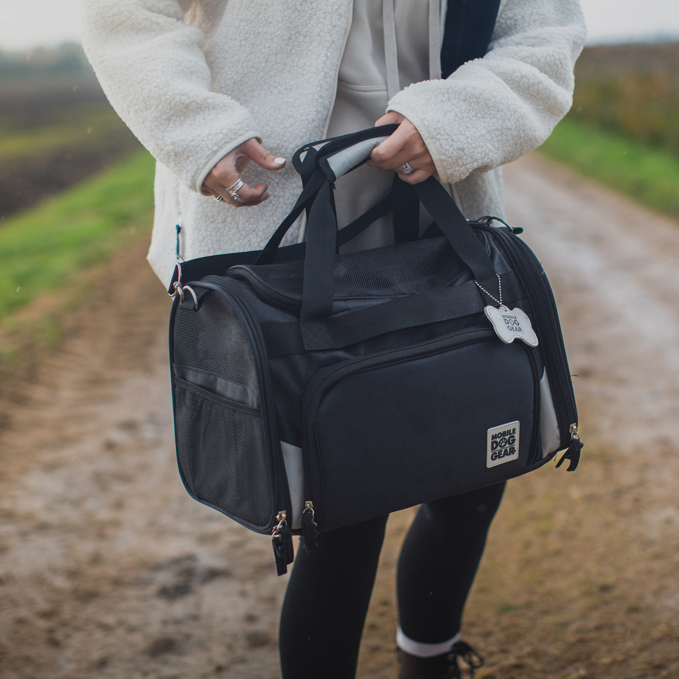 Discover, Mobile Dog Gear Pet Carrier, in Black. The Perfect Away Bag for any Pet Parent, Featuring dividers to stack food and removable padded Bottom. Also Included feeding set, collapsible silicone bowls and placemat! The Perfect Gift For travel, meets airline requirements. Available Now at Lords & Labradors