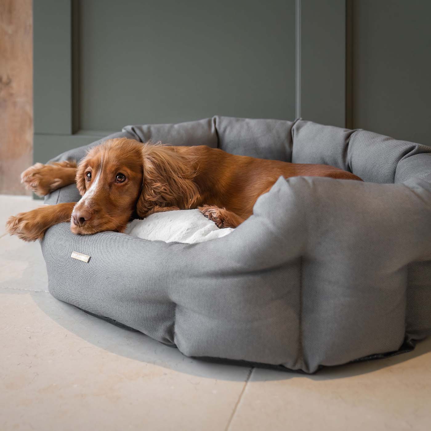 Discover our luxury twill oval dog bed in beautiful sandstone, the ideal choice for dogs to enjoy blissful nap-time, featuring reversible inner cushion with raised sides for dogs who love to rest their head for the ultimate cosiness! Handcrafted in Italy for pure pet luxury! Available now at Lords & Labradors    